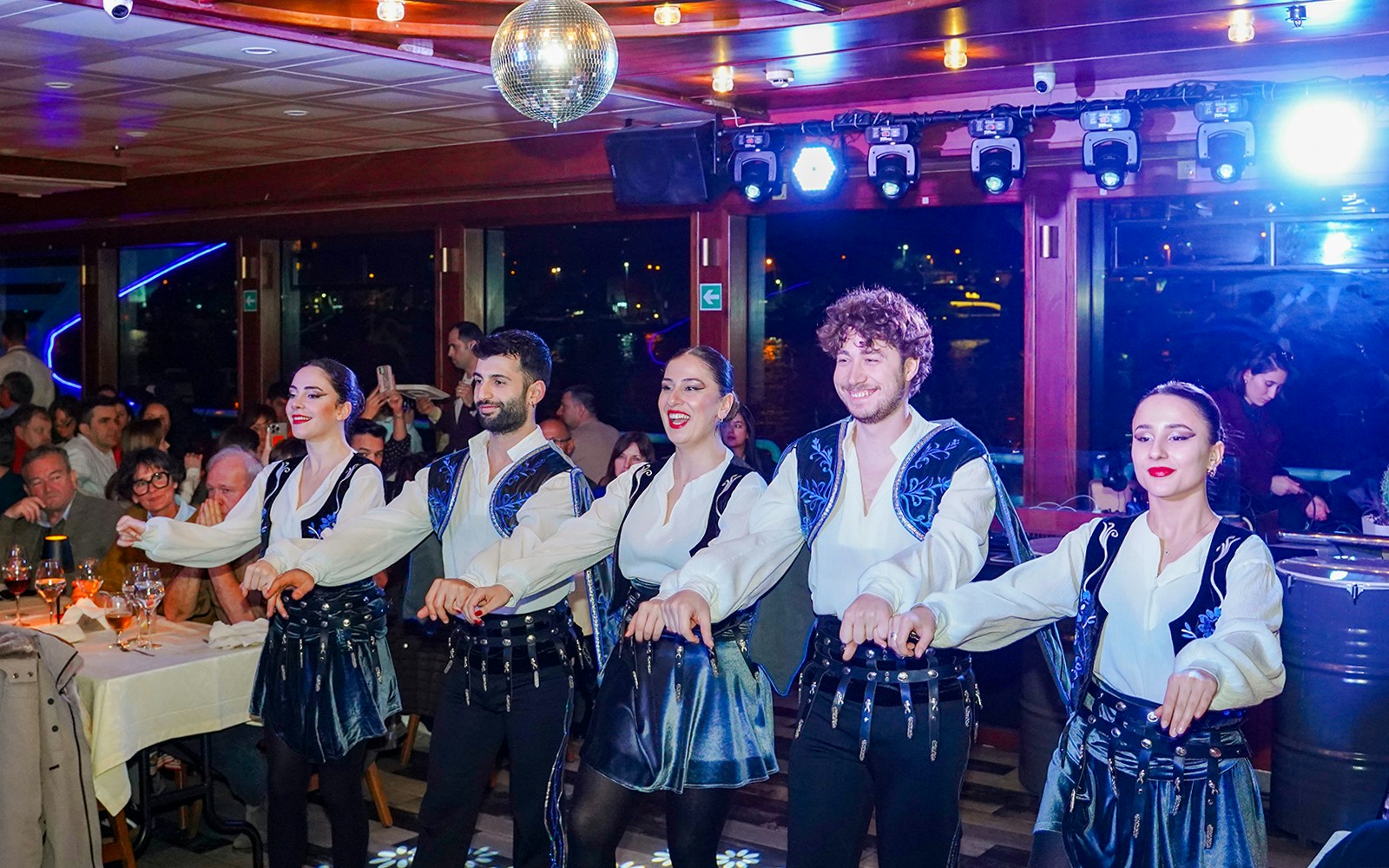 Bosphorus dinner cruise with live entertainment, Istanbul skyline in the background.