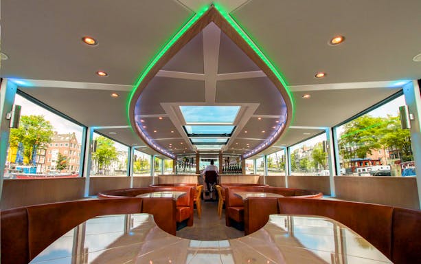 Interior of VIP Canal Cruise de Luxe on Stan Huygens with seating and bar in Amsterdam.