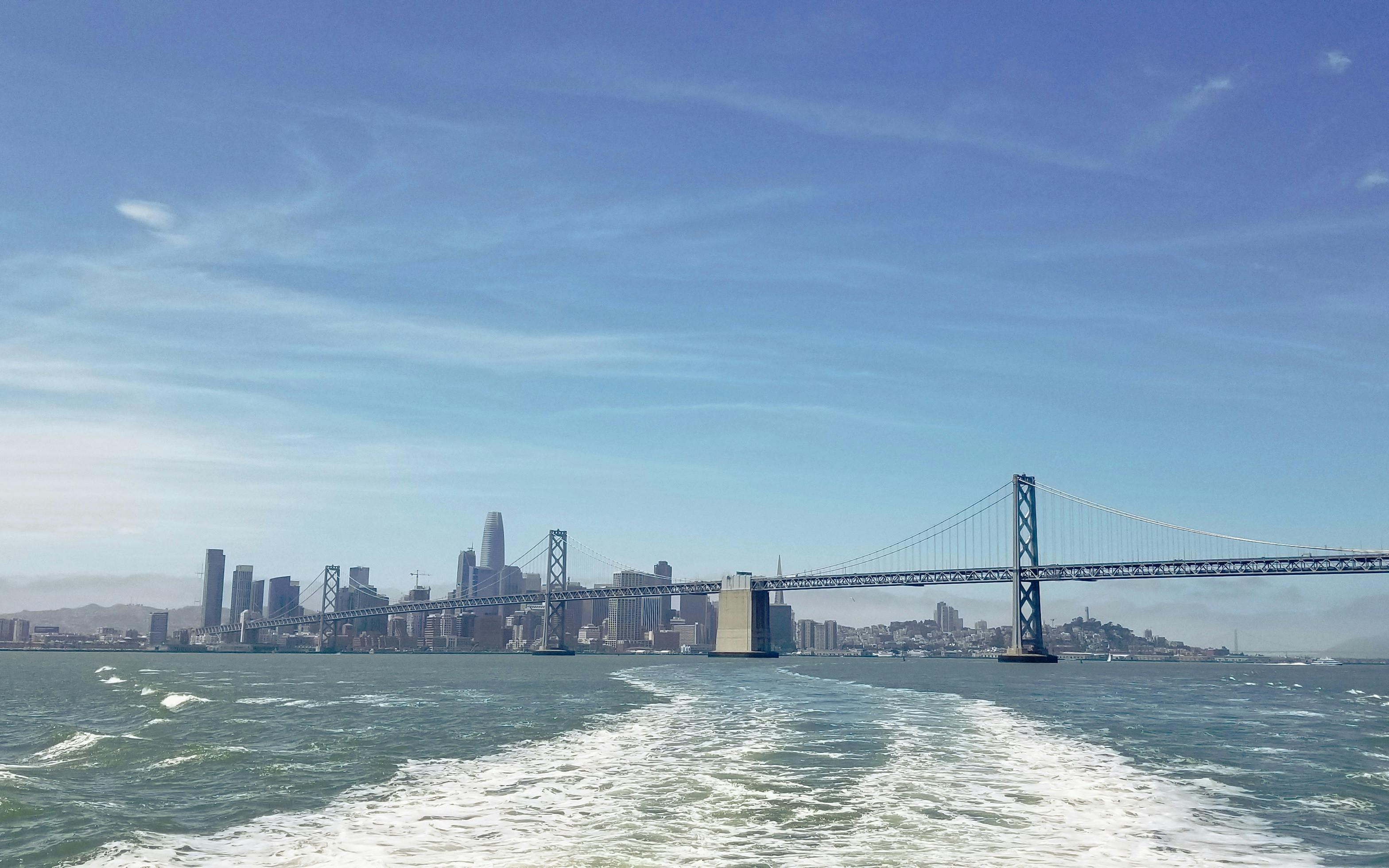 San Francisco skyline and Bay Bridge viewed from a boat on the Bridge to Bridge Cruise.