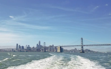 San Francisco skyline and Bay Bridge viewed from a boat on the Bridge to Bridge Cruise.