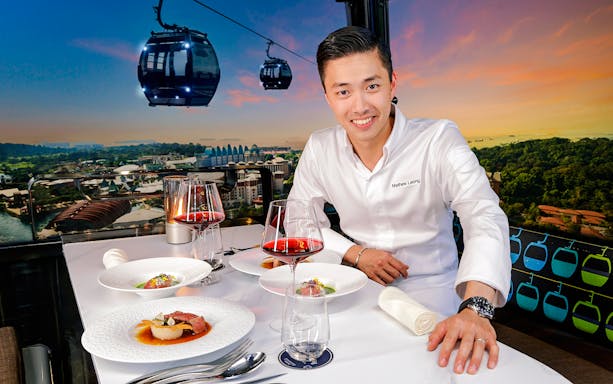 Singapore cable car dining with dishes by Chef Mathew Leong, overlooking city skyline.