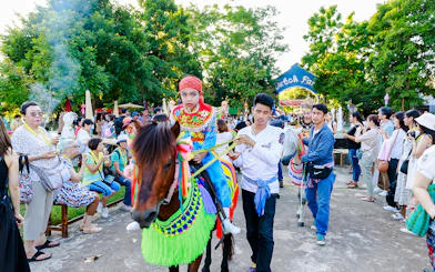 Young boy in traditional attire on a decorated horse at Chiang Mai Sky Lanterns Festival parade.