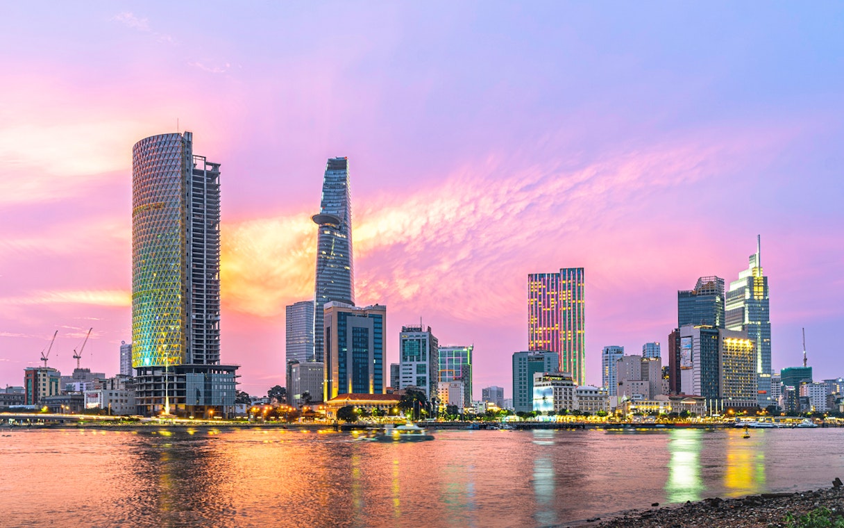 Cityscape of Ho Chi Minh City with Saigon River at sunset.