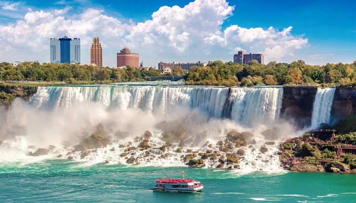 Hornblower Cruise boat approaching Niagara Falls, Canada with mist rising from the waterfall.
