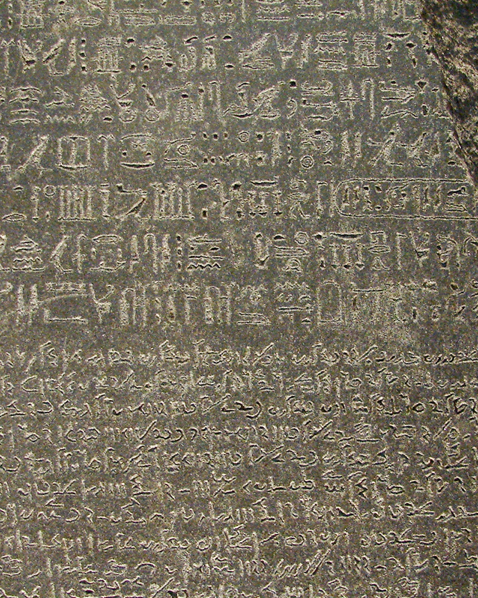 Rosetta Stone inscriptions at the British Museum, London, featuring ancient scripts.