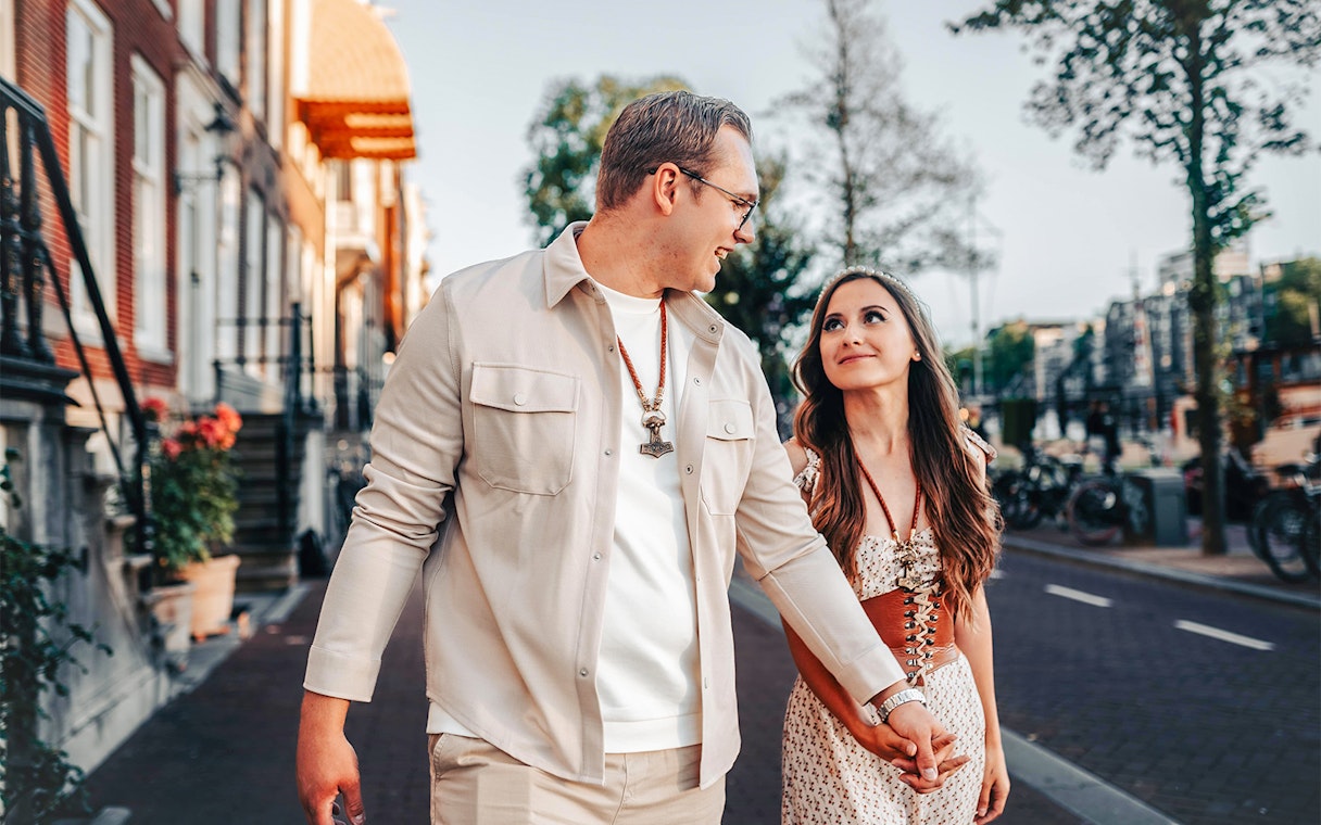 Couple walking near Magere Brug in Amsterdam during a professional photoshoot.