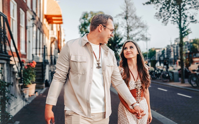 Couple walking near Magere Brug in Amsterdam during a professional photoshoot.