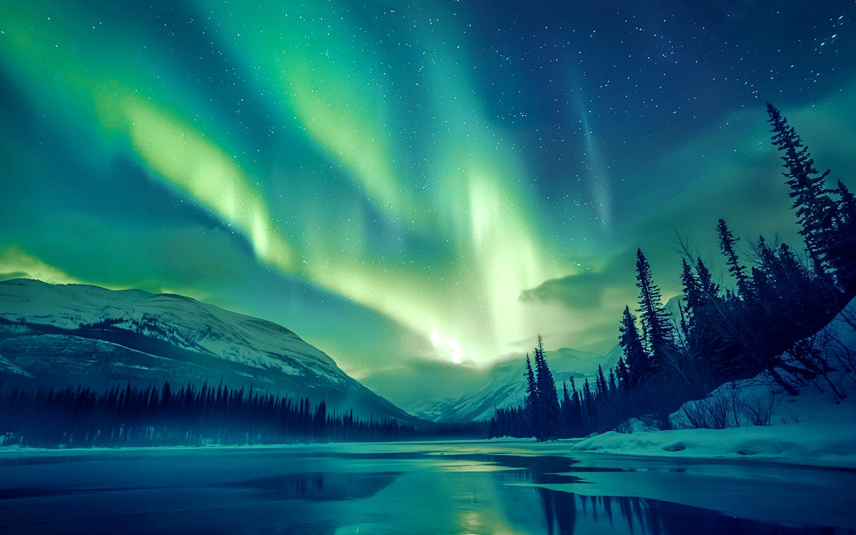 Northern Lights over snowy landscape in Rovaniemi, Finland.