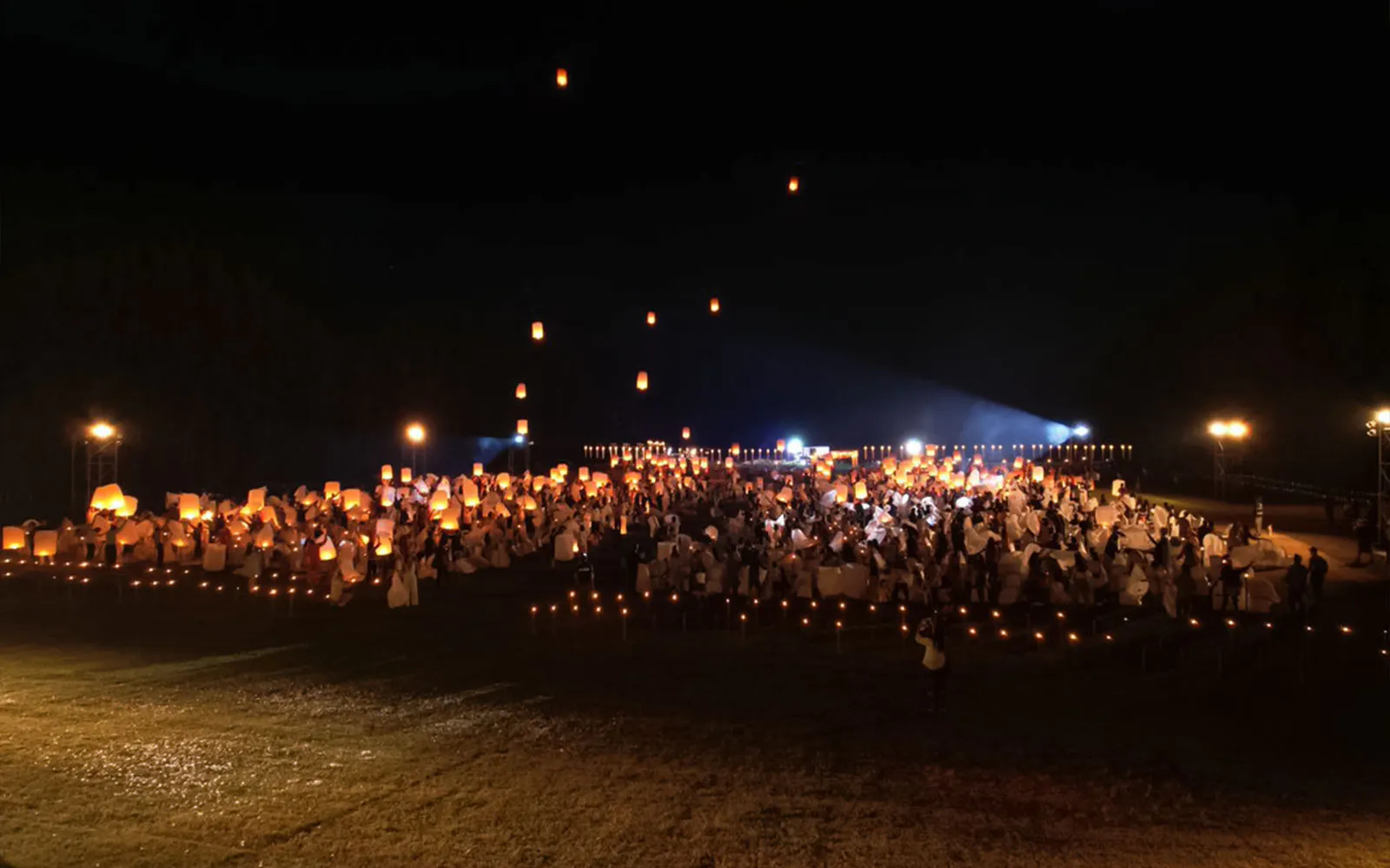 Lanterns released into the night sky at Yeepeng Lanna Festival 2023, Thailand.
