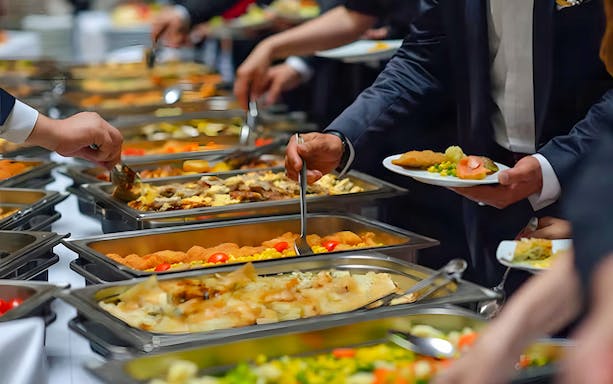 Buffet dinner on Nile River cruise in Cairo with guests serving food.