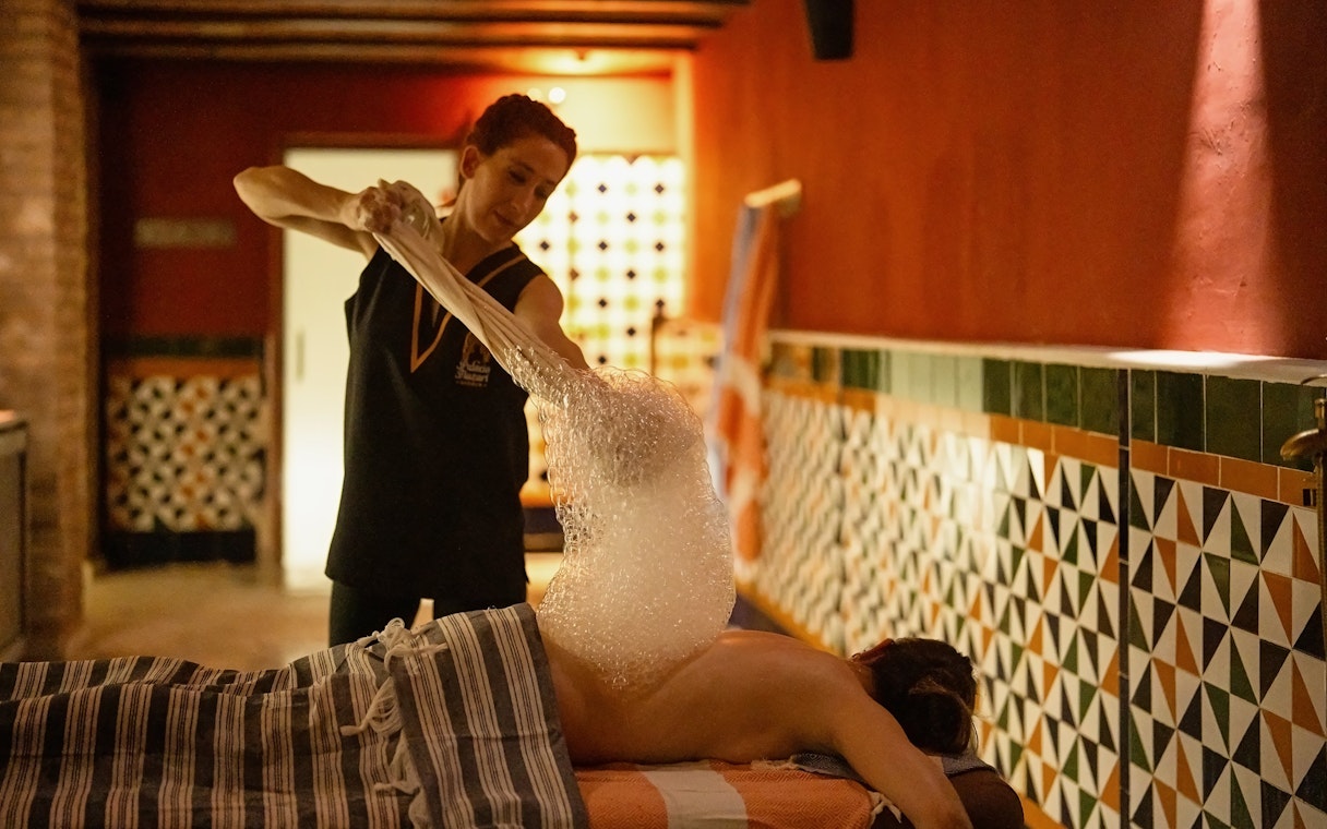 Visitors enjoying a traditional Hammam bubble bath in Granada.