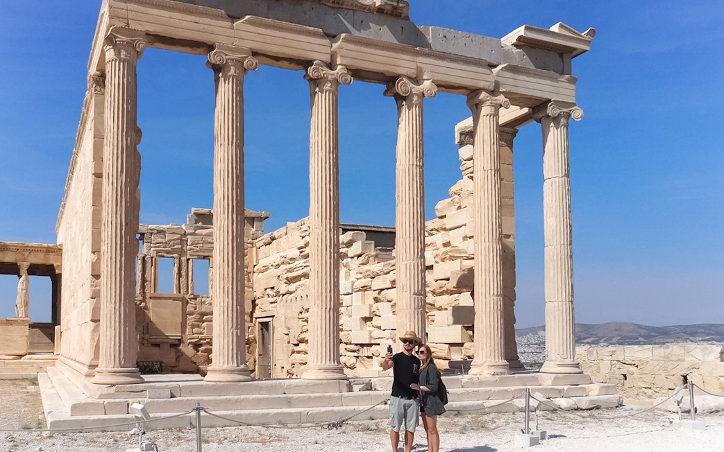 Tourist taking selfie in front of Parthenon, Athens, Greece.