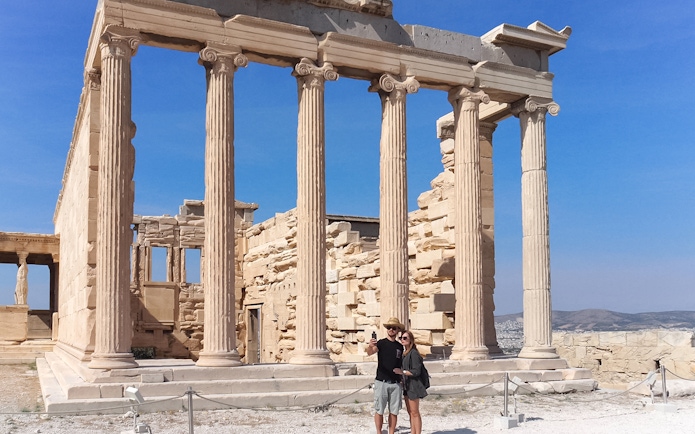 Tourist taking selfie in front of Parthenon, Athens, Greece.