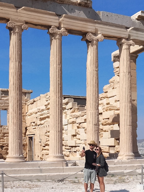 Tourist taking selfie in front of Parthenon, Athens, Greece.