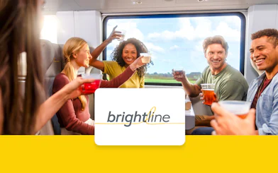 Passengers enjoying drinks on the Brightline train from Miami to Orlando.