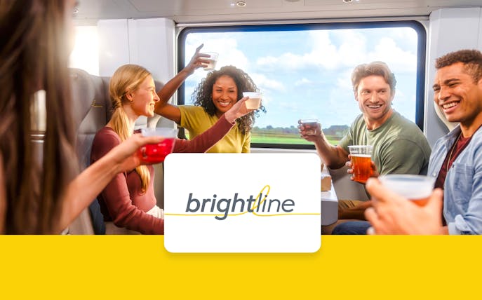 Passengers enjoying drinks on the Brightline train from Miami to Orlando.