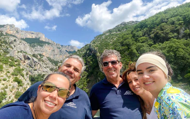 Group enjoying the view at Pont de Galetas with scenic mountains in the background.