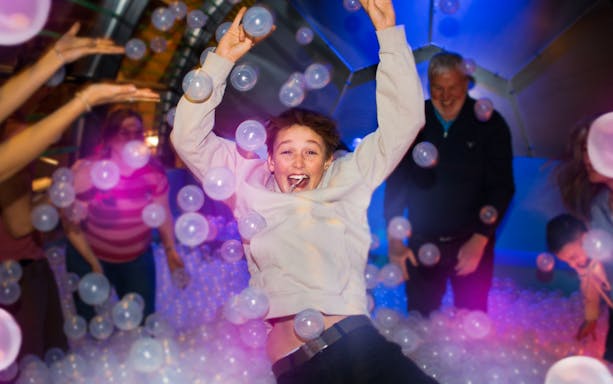 Person enjoying bubble room experience at The TUBE in Copenhagen.