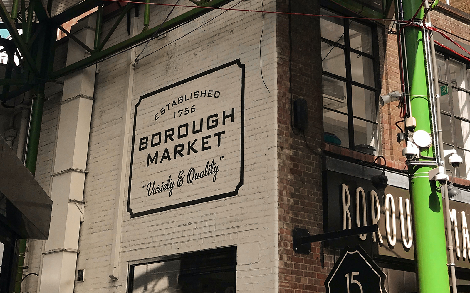 Borough Market sign on a brick wall in London, highlighting its establishment in 1756.