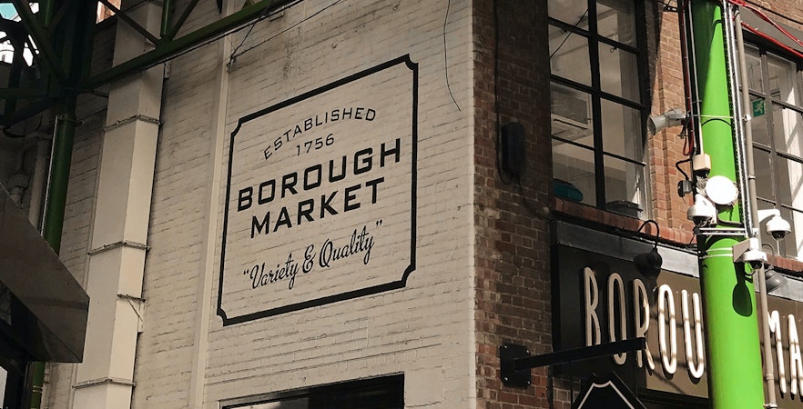 Borough Market sign on a brick wall in London, highlighting its establishment in 1756.