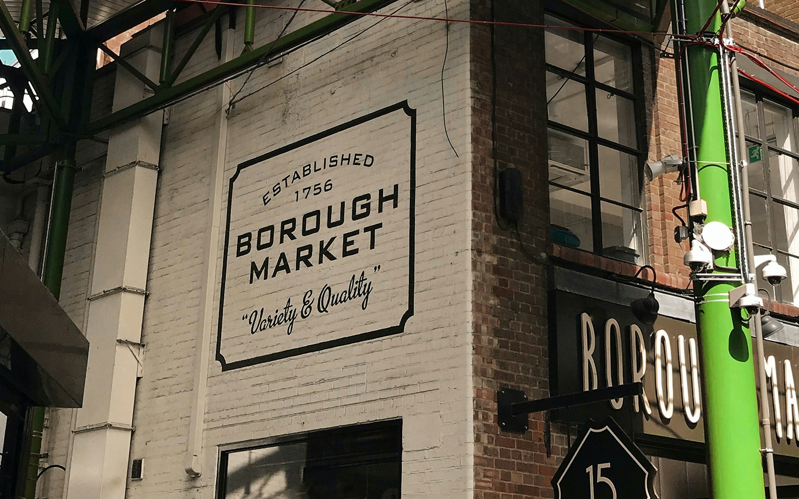 Borough Market stalls with fresh produce and visitors in London.