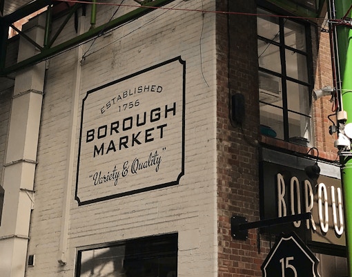 Borough Market sign on a brick wall in London, highlighting its establishment in 1756.