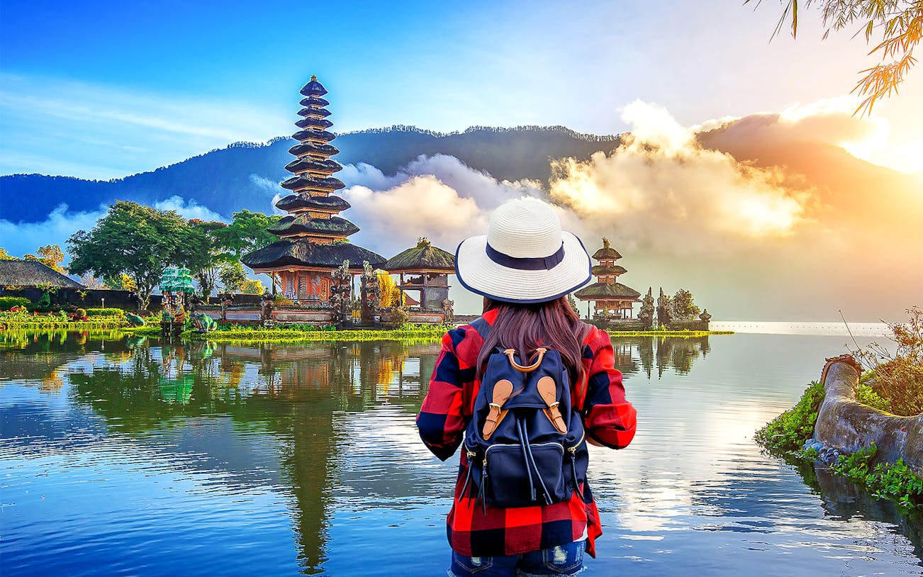 Traveler viewing Ulun Danu Beratan Temple on Bali Private Bedugul, Tanah Lot Sunset Tour.