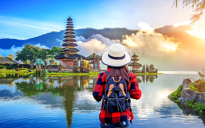 Traveler viewing Ulun Danu Beratan Temple on Bali Private Bedugul, Tanah Lot Sunset Tour.