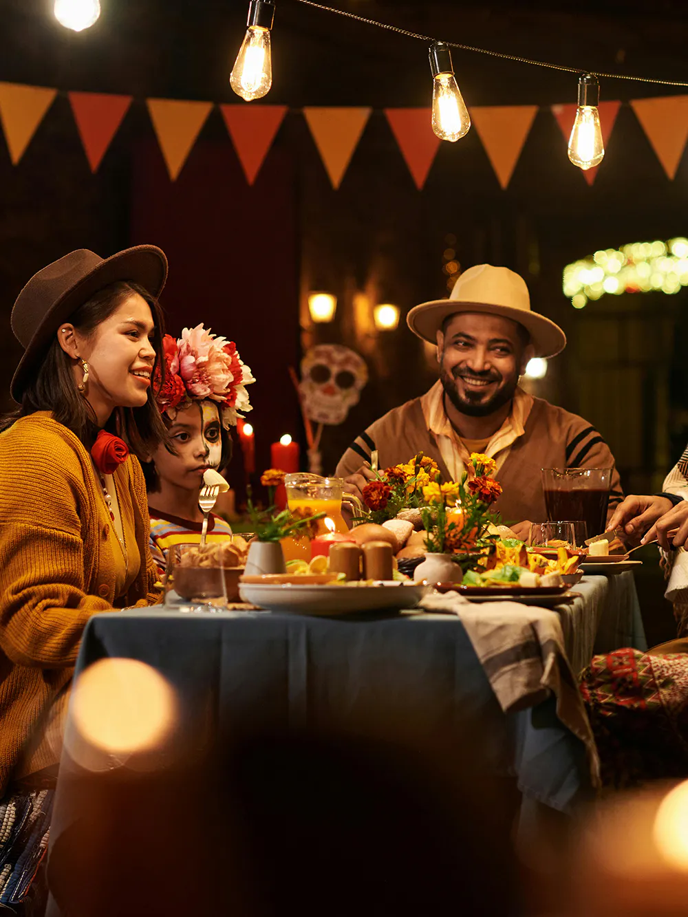 Friends dining at a festive restaurant table with decorations and traditional food.