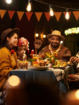 Friends dining at a festive restaurant table with decorations and traditional food.