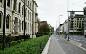 Street view of Berlin with historic architecture and tram, part of the Secrets of Berlin Spy Mission game.