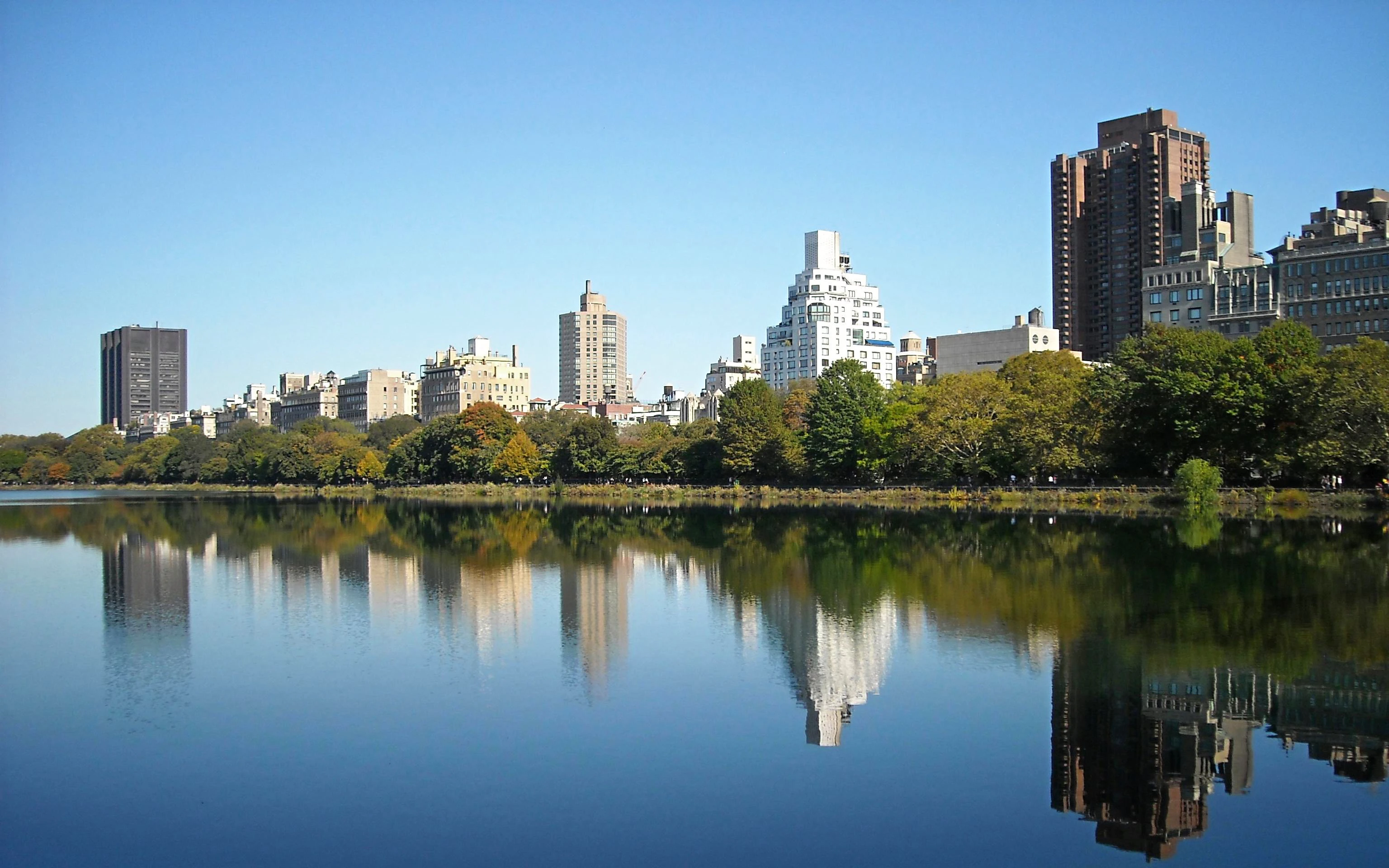 Skyline view across Jacqueline Kennedy Onassis Reservoir in New York City's Upper West Side.
