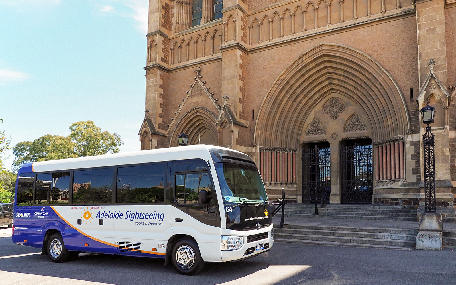 Tour bus in front of a historic building in Adelaide Hills, Australia.