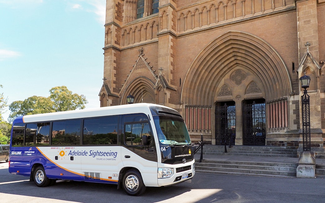 Tour bus in front of a historic building in Adelaide Hills, Australia.