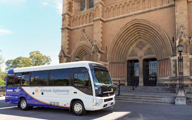 Tour bus in front of a historic building in Adelaide Hills, Australia.