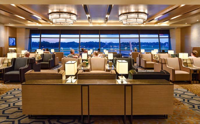 Plaza Premium Lounge seating area with travelers at Singapore airport.