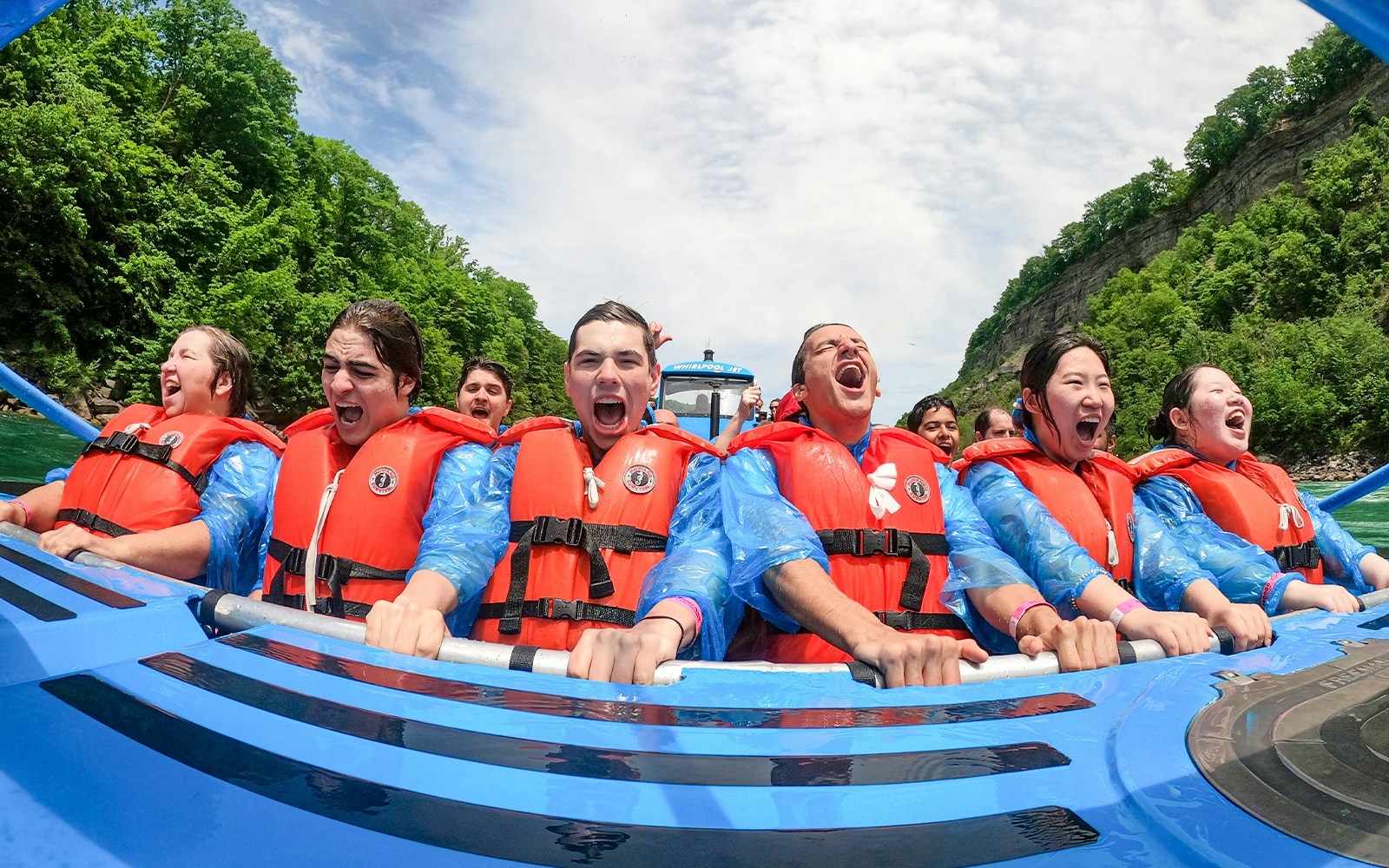 Guests enjoying a thrilling Whirlpool Jet Boat Tour in Niagara Gorge, Canada.