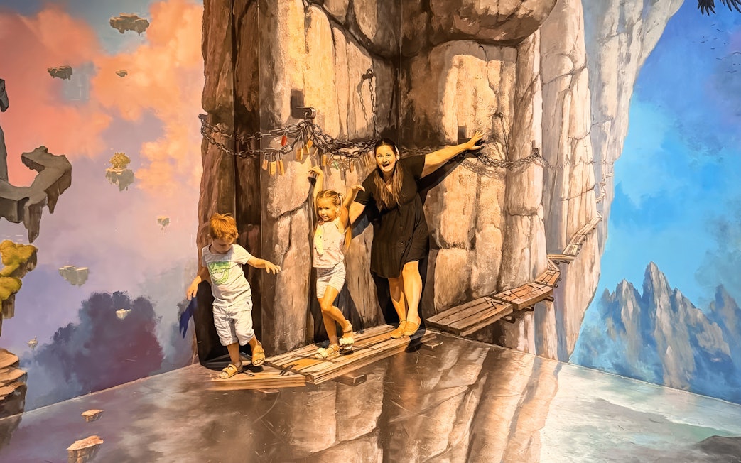 Visitors interacting with cliff illusion at ArtVo Melbourne Trick-Art Gallery.