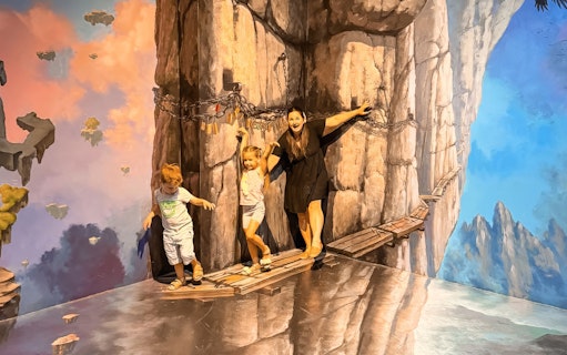 Visitors interacting with cliff illusion at ArtVo Melbourne Trick-Art Gallery.