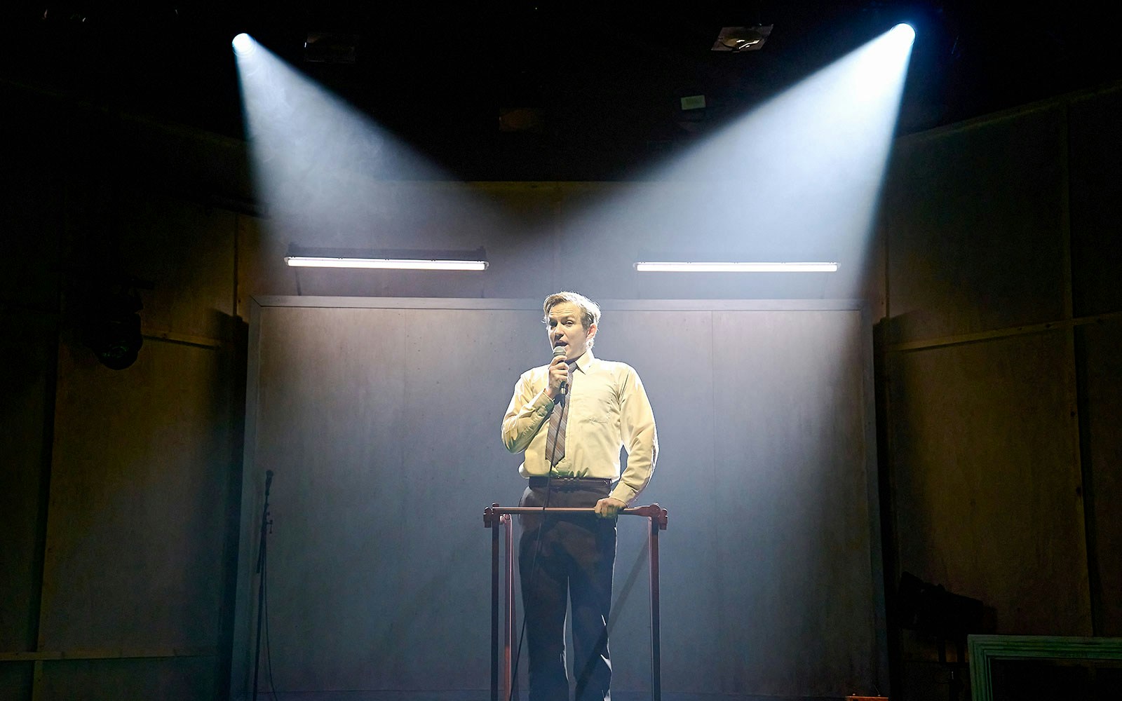 Performer on stage during Kenrex show under spotlight.