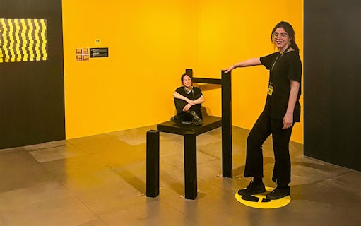 Visitors interacting with an optical illusion exhibit at the Museum of Illusions Genoa.