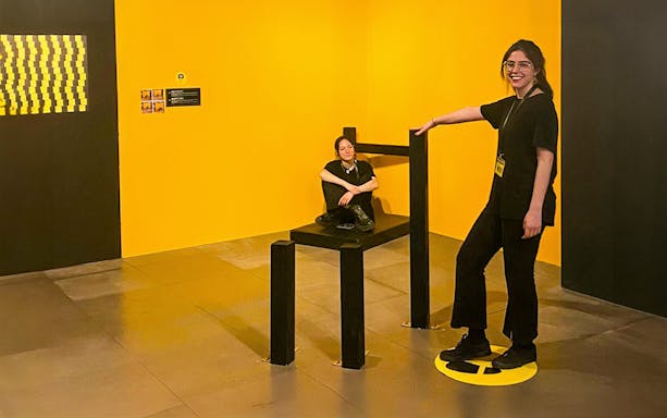 Visitors interacting with an optical illusion exhibit at the Museum of Illusions Genoa.