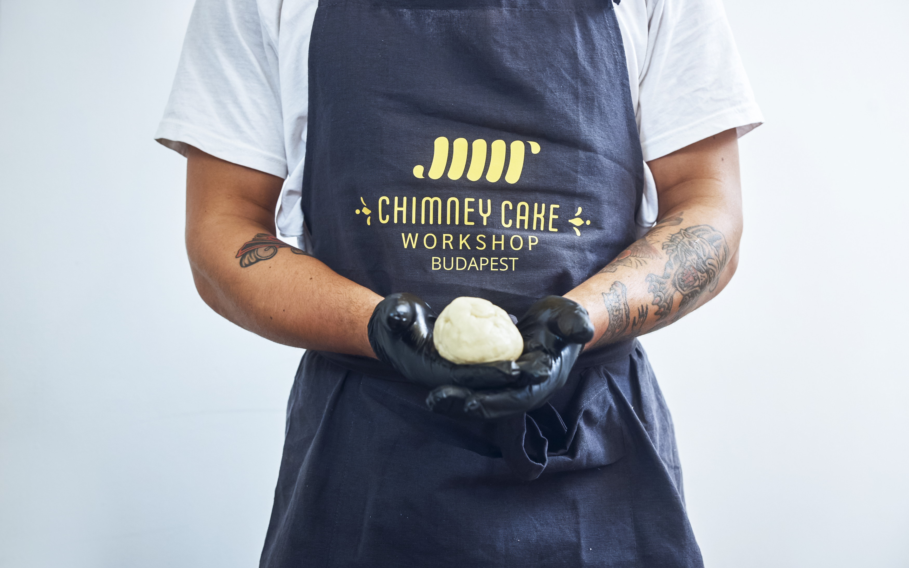 Chimney Cake Workshop participant holding dough in Budapest.