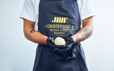 Chimney Cake Workshop participant holding dough in Budapest.