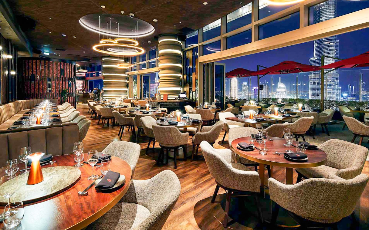 Luxurious dining area at CLV restaurant with city skyline view.