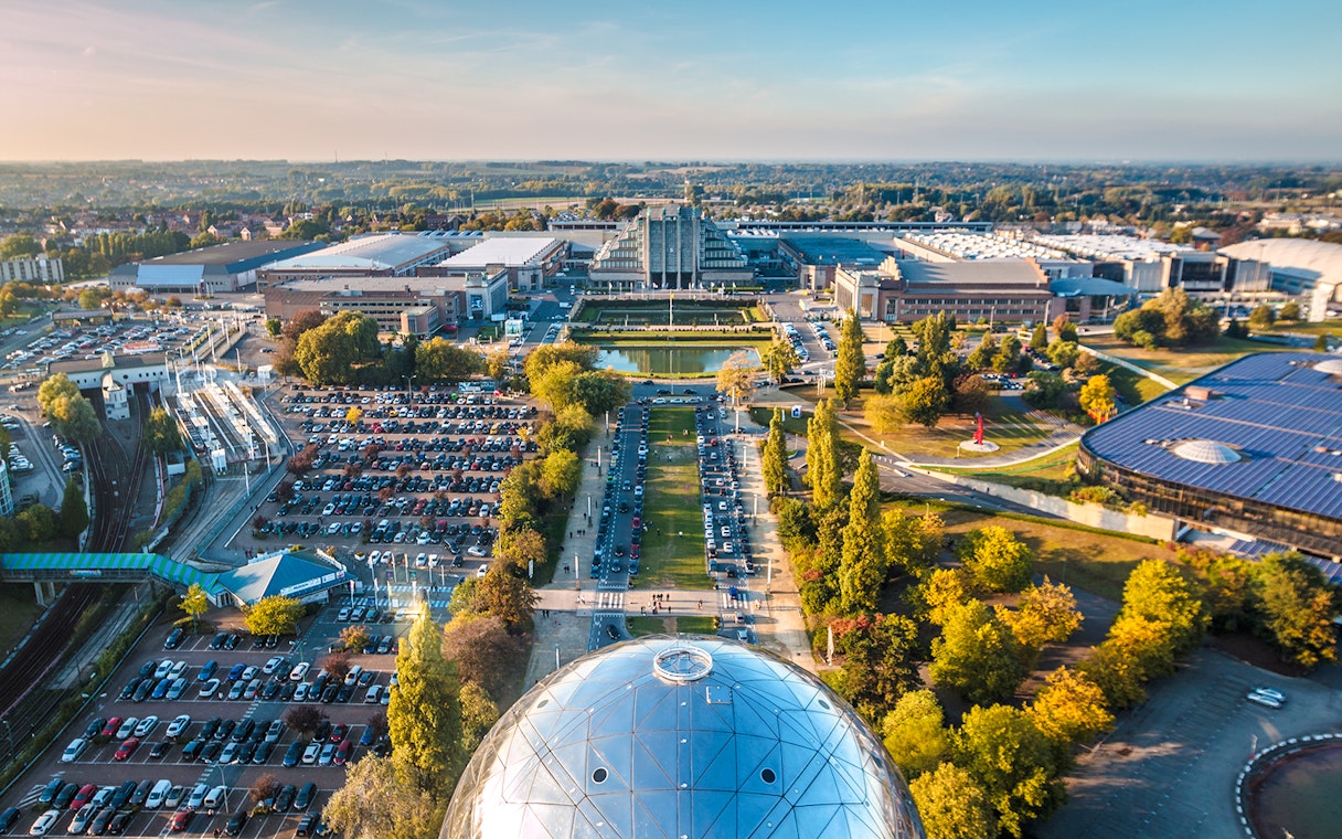 Aerial view of Brussels from Atomium, showcasing cityscape and surrounding greenery.