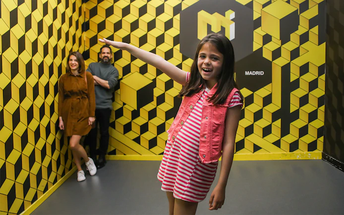 Visitors enjoying an optical illusion at the Museum of Illusions in Madrid.