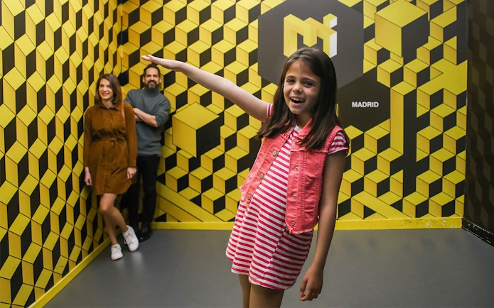 Visitors enjoying an optical illusion at the Museum of Illusions in Madrid.