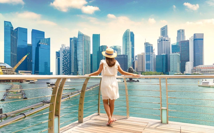 Woman overlooking Marina Bay Sands skyline in Singapore.