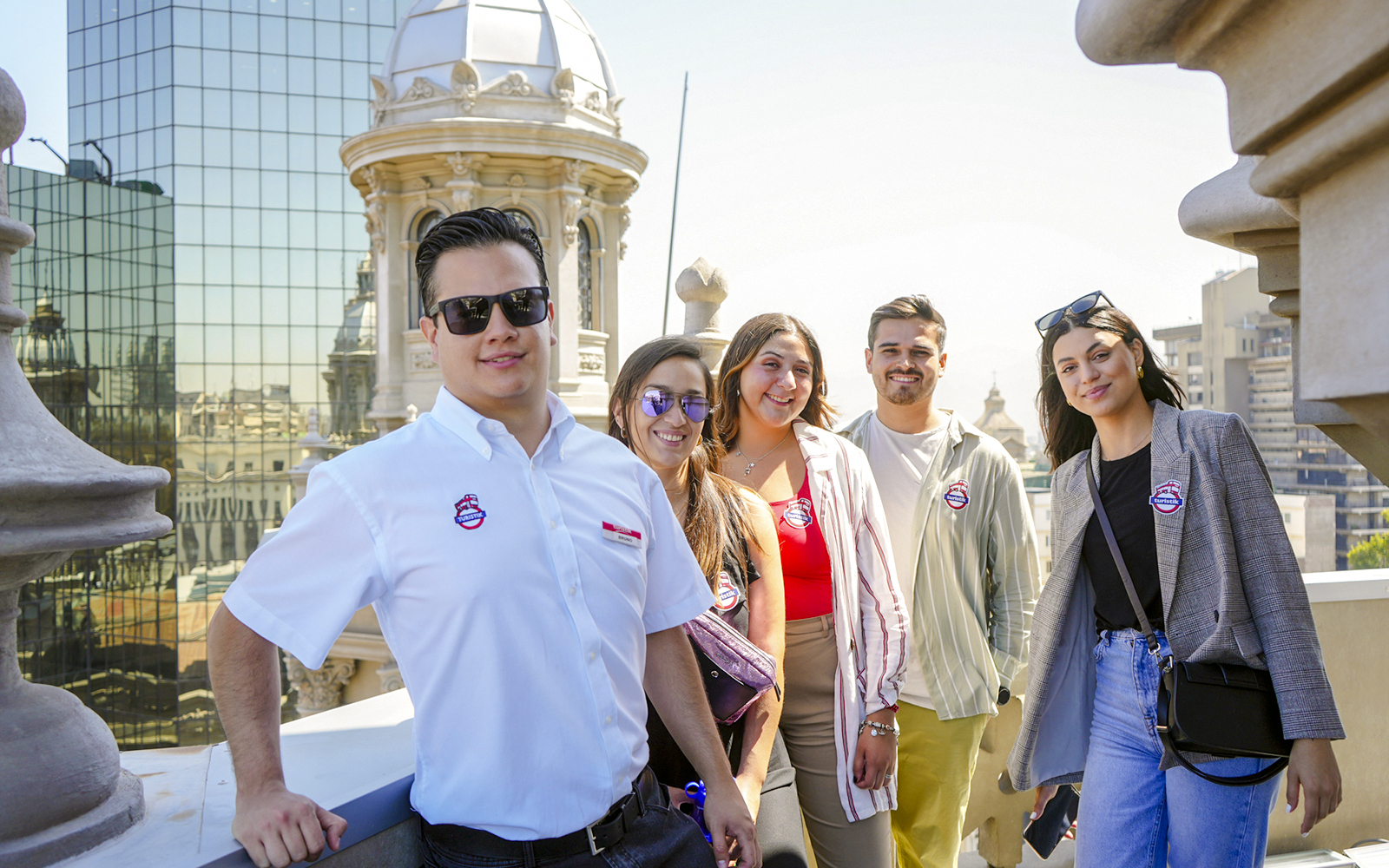 Guests with guide on Santiago Cathedral Bell Tower terrace with city view.